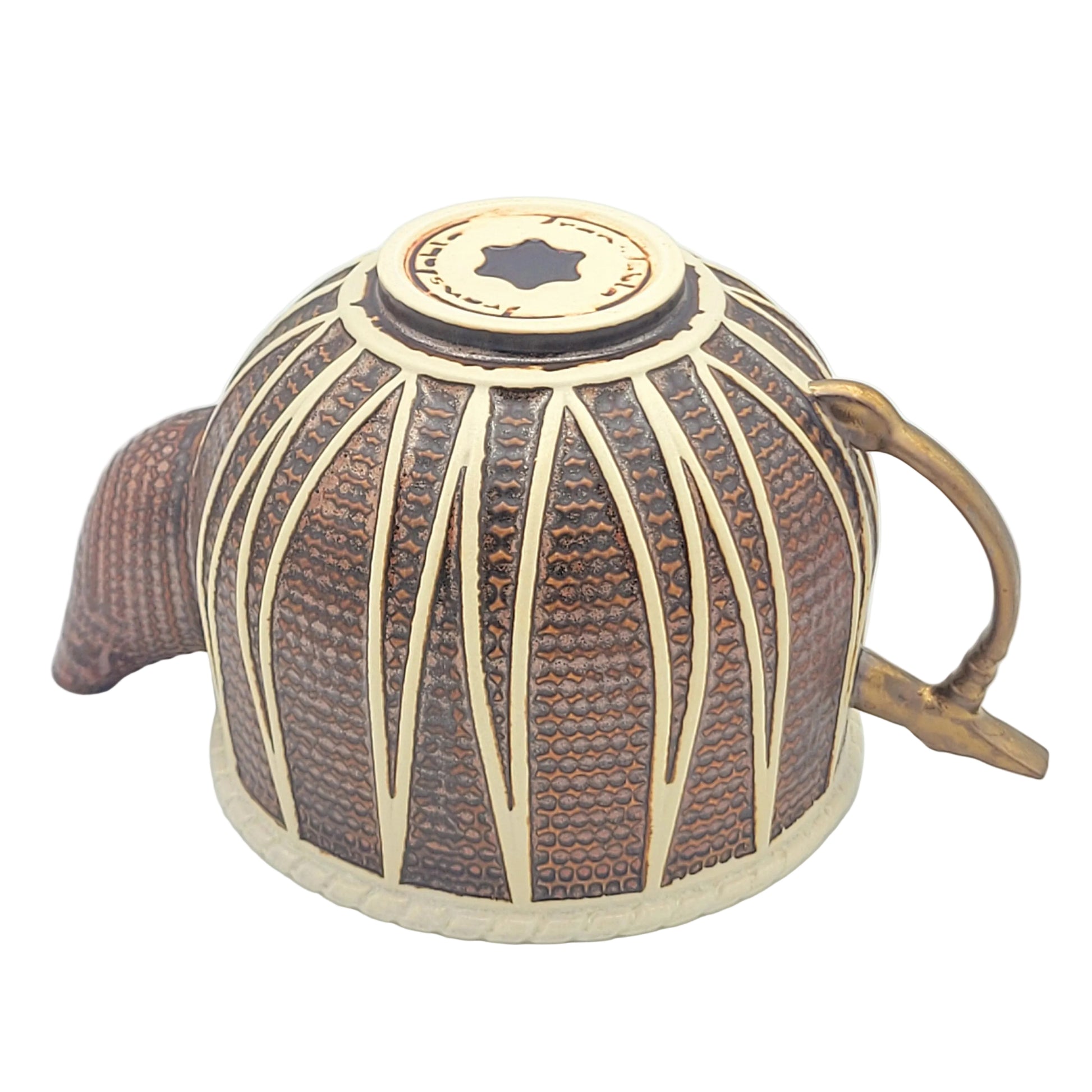 A decorative ceramic teapot with copper colored glaze, featuring a curved spout, a tabla hammer gold glazed handle, viewed from the bottom.
