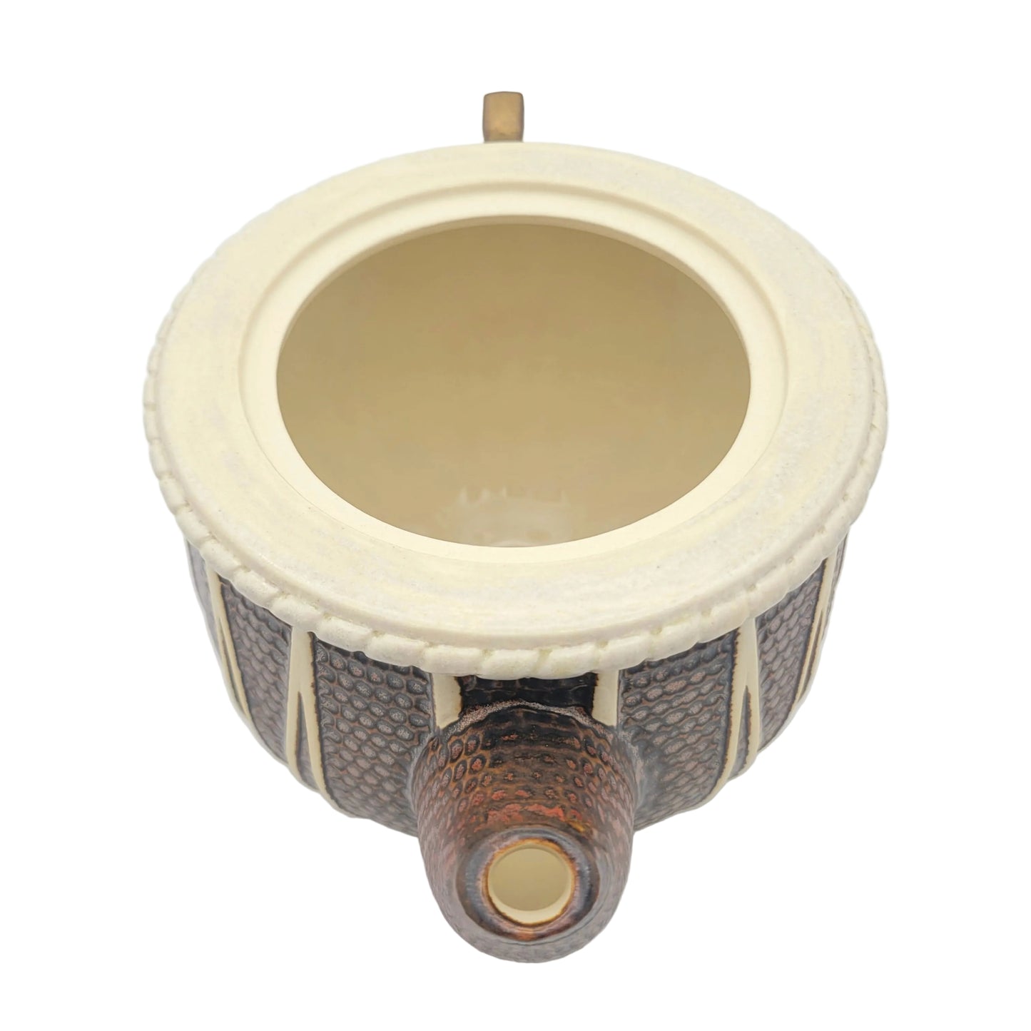 A ceramic teapot viewed from above, featuring a cream-colored interior and rim, a copper glazed exterior, and a hammered copper-toned spout with a cream interior.