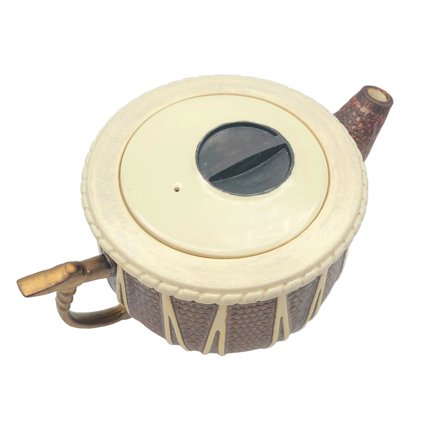 A ceramic teapot with a textured copper glazed body, a cream-colored lid, and brass-toned metal tabla hammer handle. hown on a plain white background.